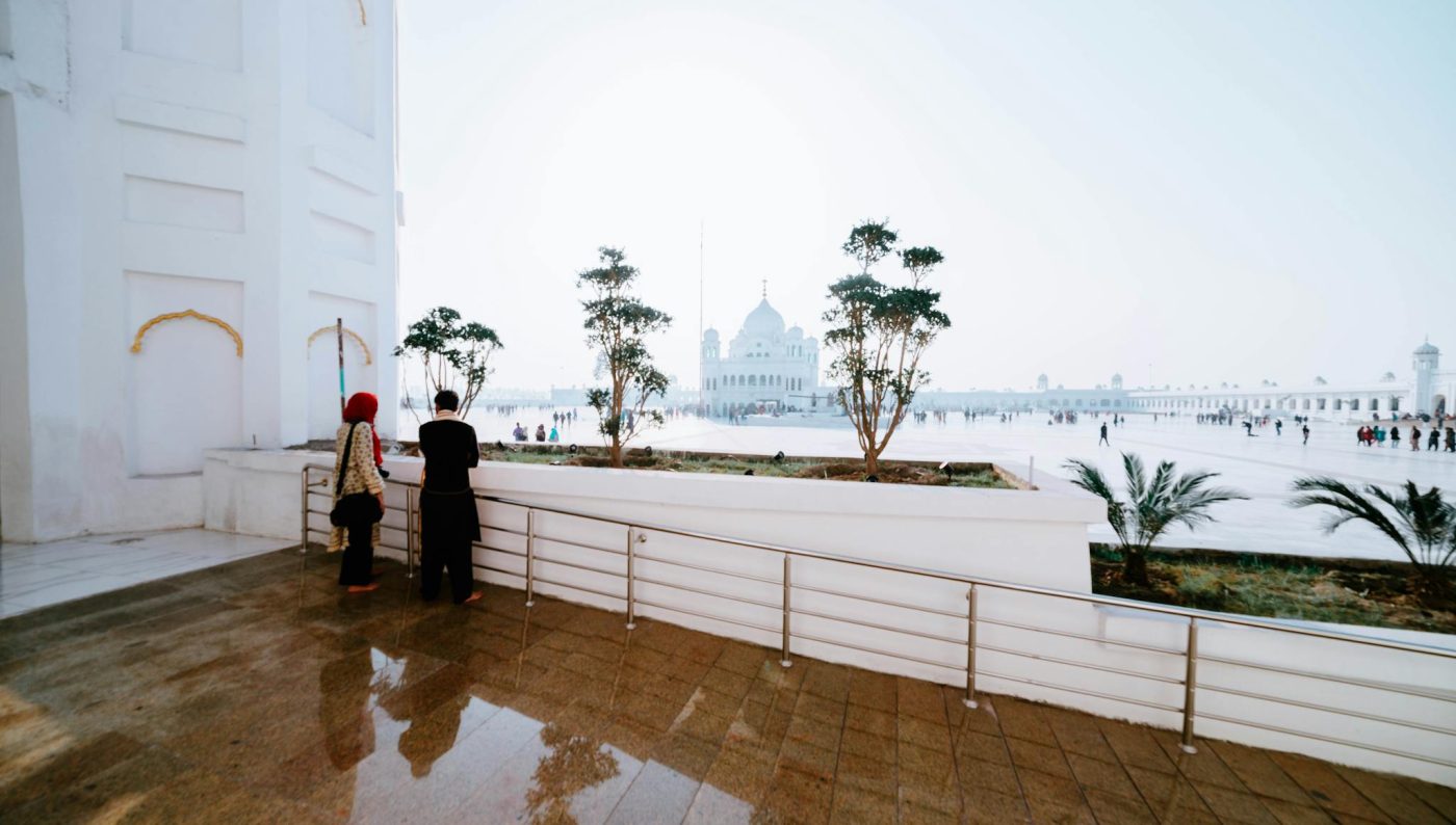 A calm scene at Gurdwara Darbar Sahib showing visitors enjoying the tranquil atmosphere.