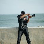 A casual photographer captures a moment by the sea on a sunny day.