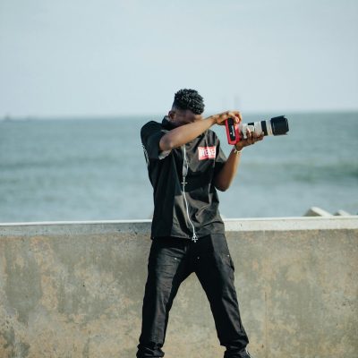 A casual photographer captures a moment by the sea on a sunny day.