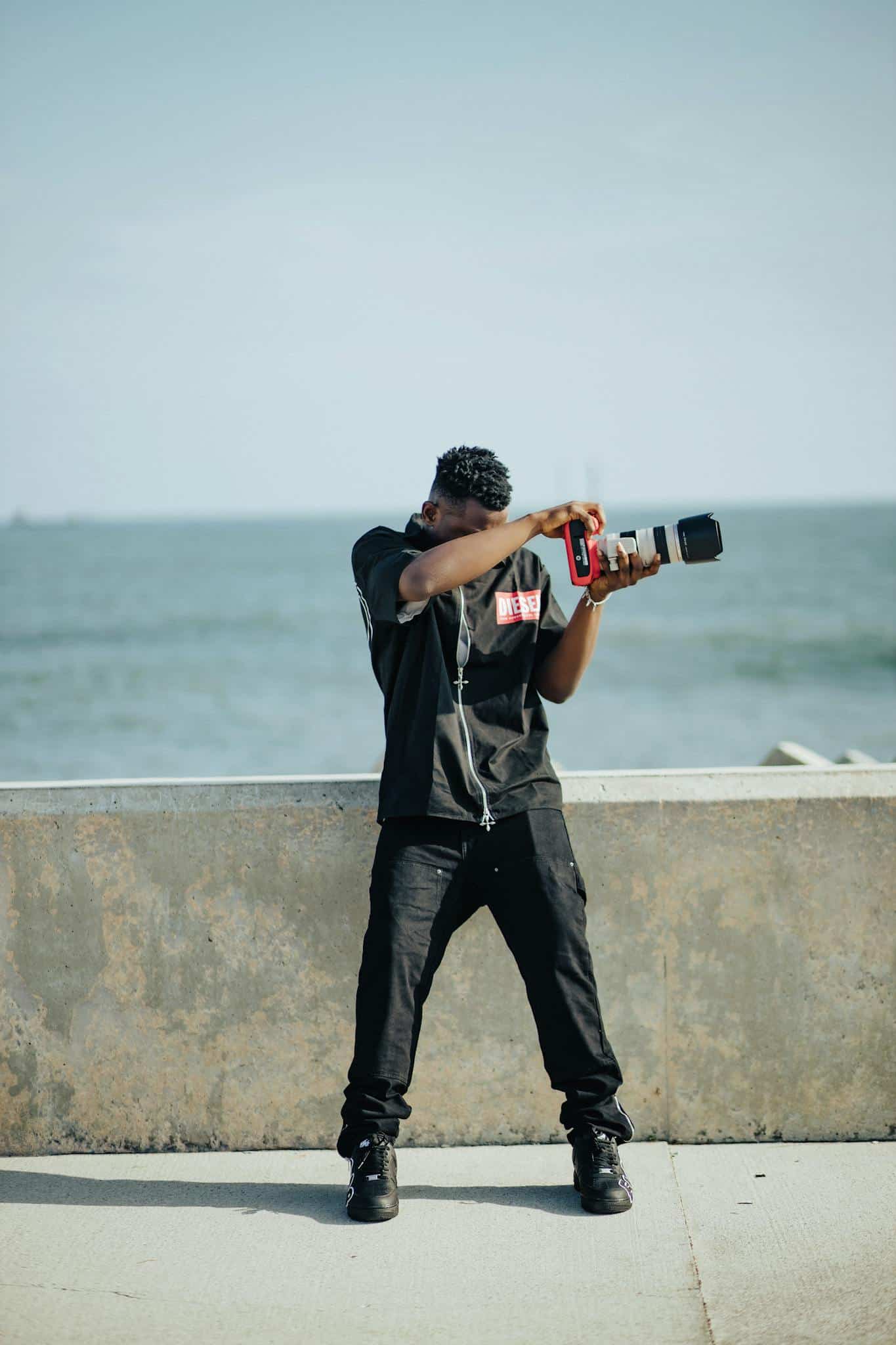 A casual photographer captures a moment by the sea on a sunny day.